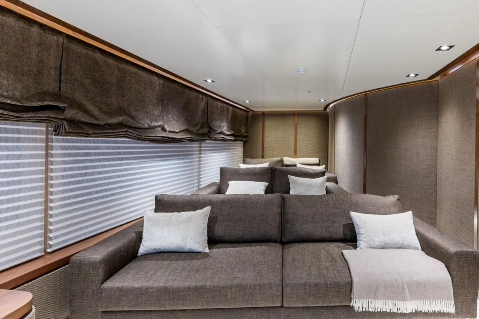 a couch with a large window aboard MAYBE Yacht for Sale