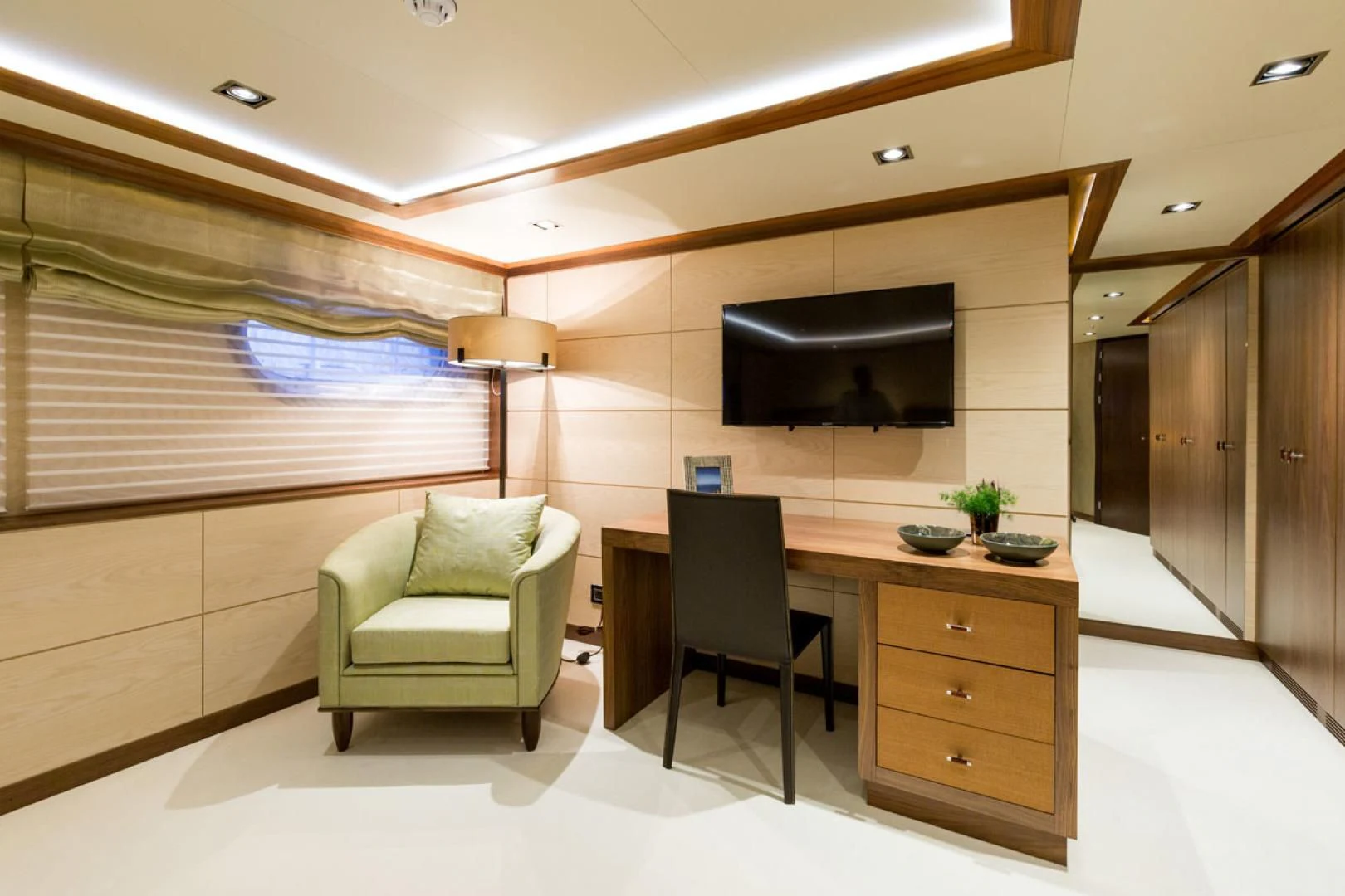 a room with a tv and a chair aboard MAYBE Yacht for Sale