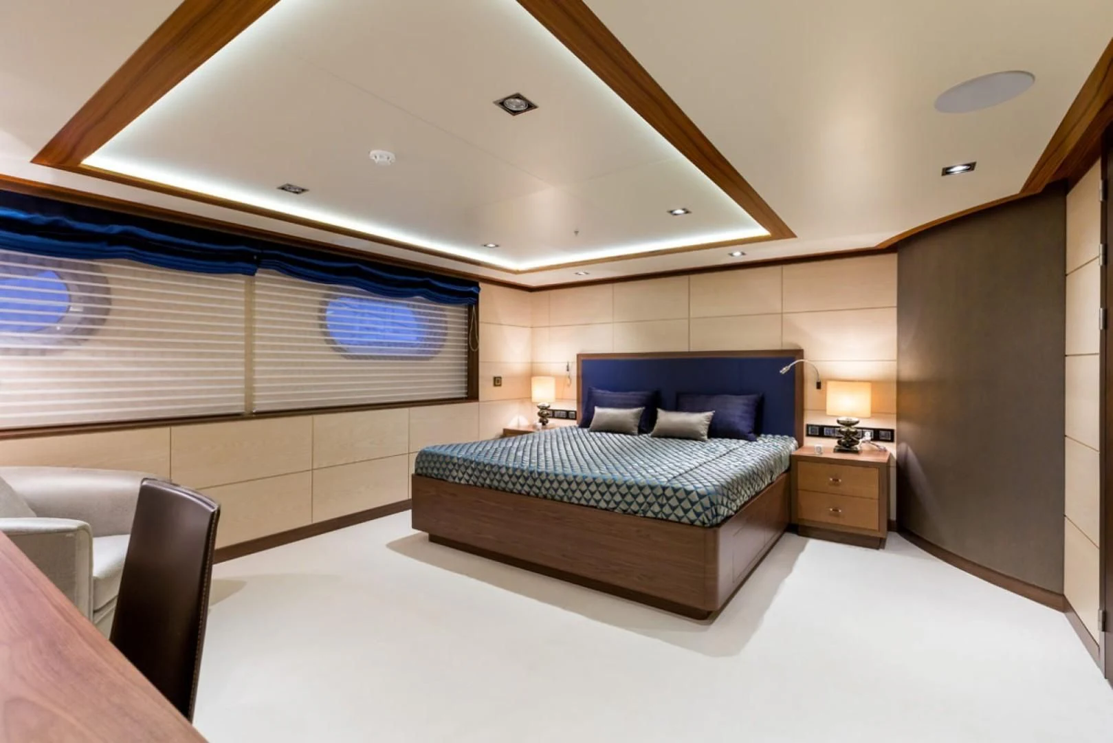 a bedroom with a bed and a desk aboard MAYBE Yacht for Sale