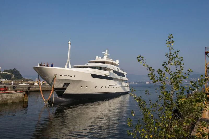 a white boat docked at a pier aboard MAYBE Yacht for Sale