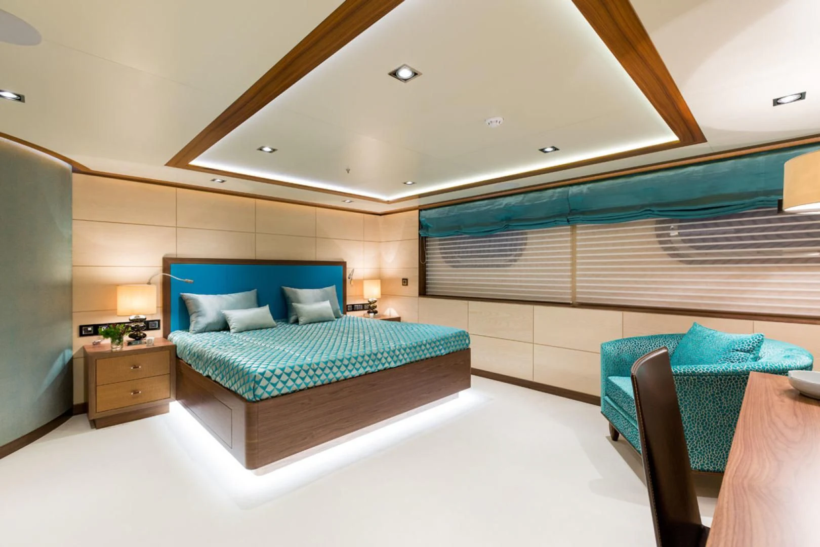 a room with a bed and a chair aboard MAYBE Yacht for Sale