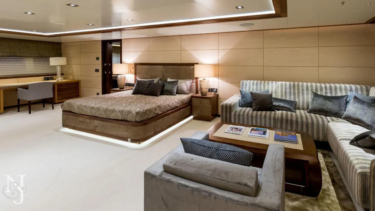 a large hotel room with a bed and a coffee table aboard MAYBE Yacht for Sale