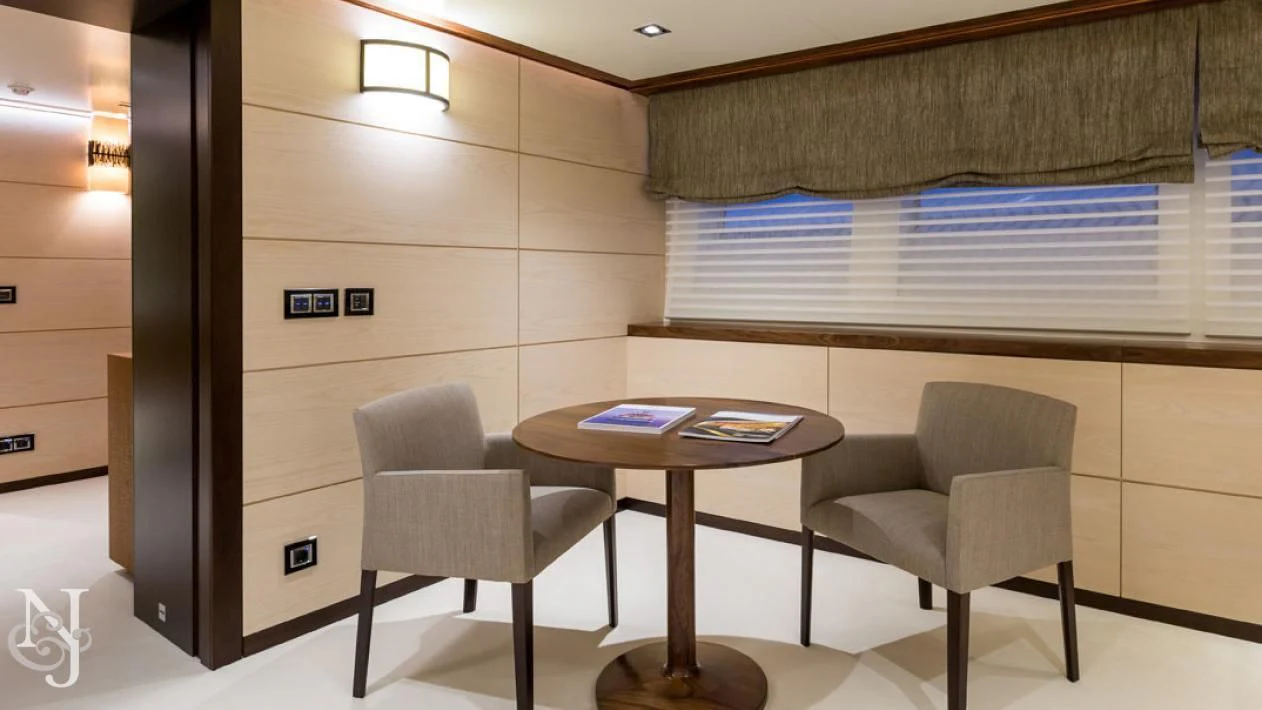 a room with a table and chairs aboard MAYBE Yacht for Sale