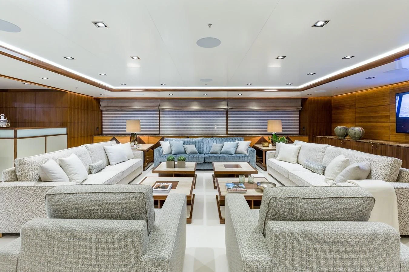 a living room with white couches aboard MAYBE Yacht for Sale