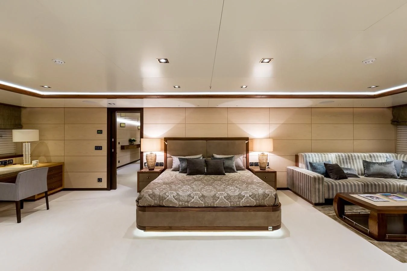 a large bedroom with a bed and a desk aboard MAYBE Yacht for Sale