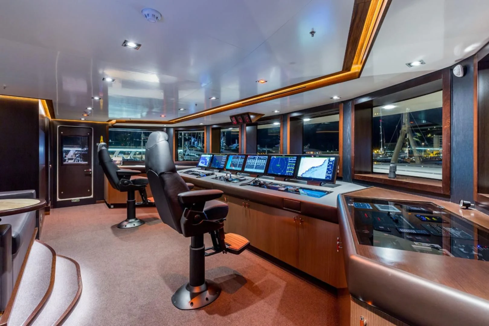 a room with a desk and chairs aboard MAYBE Yacht for Sale