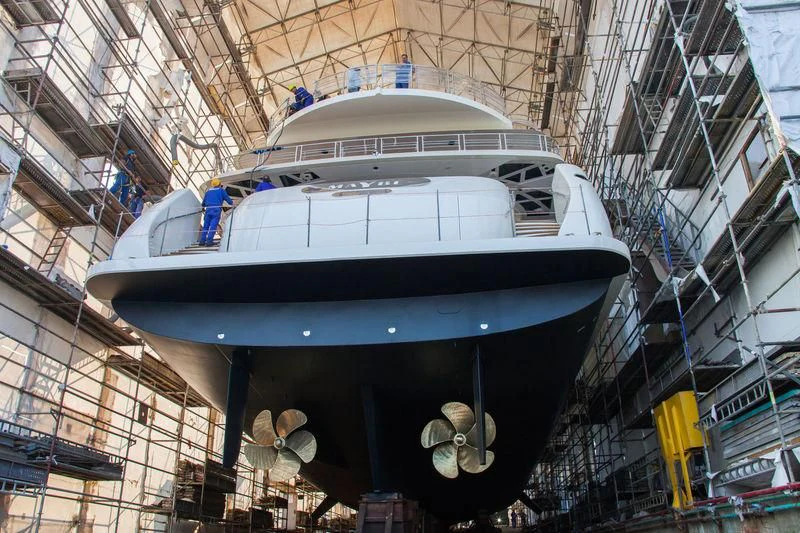 a large white ship in a large building aboard MAYBE Yacht for Sale