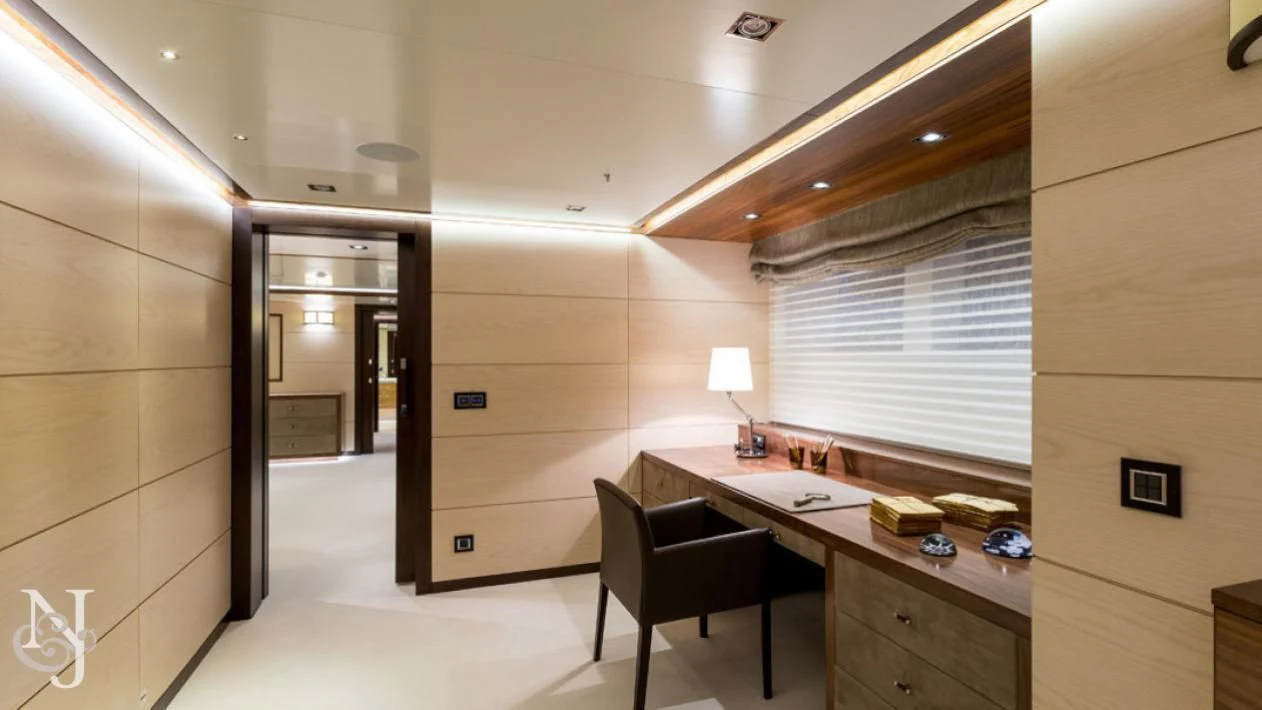 a room with a desk and a chair aboard MAYBE Yacht for Sale