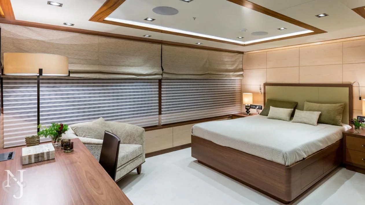 a room with a bed and a chair aboard MAYBE Yacht for Sale