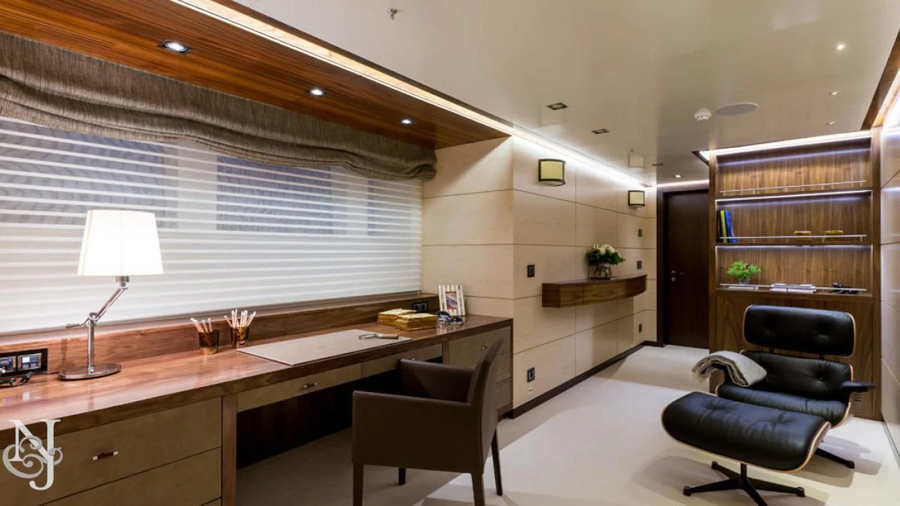 a room with a desk and a chair and a shelf with books aboard MAYBE Yacht for Sale