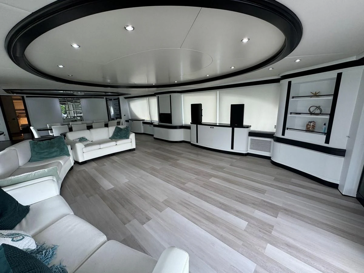 a room with a wood floor and a couch and a television aboard AZIMUT 100/32 Yacht for Sale