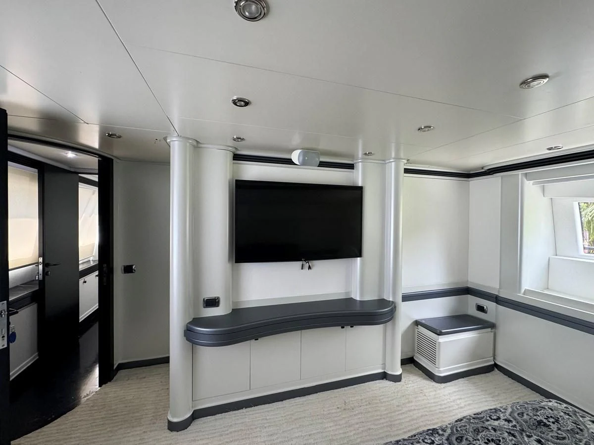 a room with a tv and a table aboard AZIMUT 100/32 Yacht for Sale