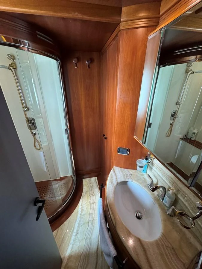 a bathroom with a sink and a mirror aboard AZIMUT 100/32 Yacht for Sale