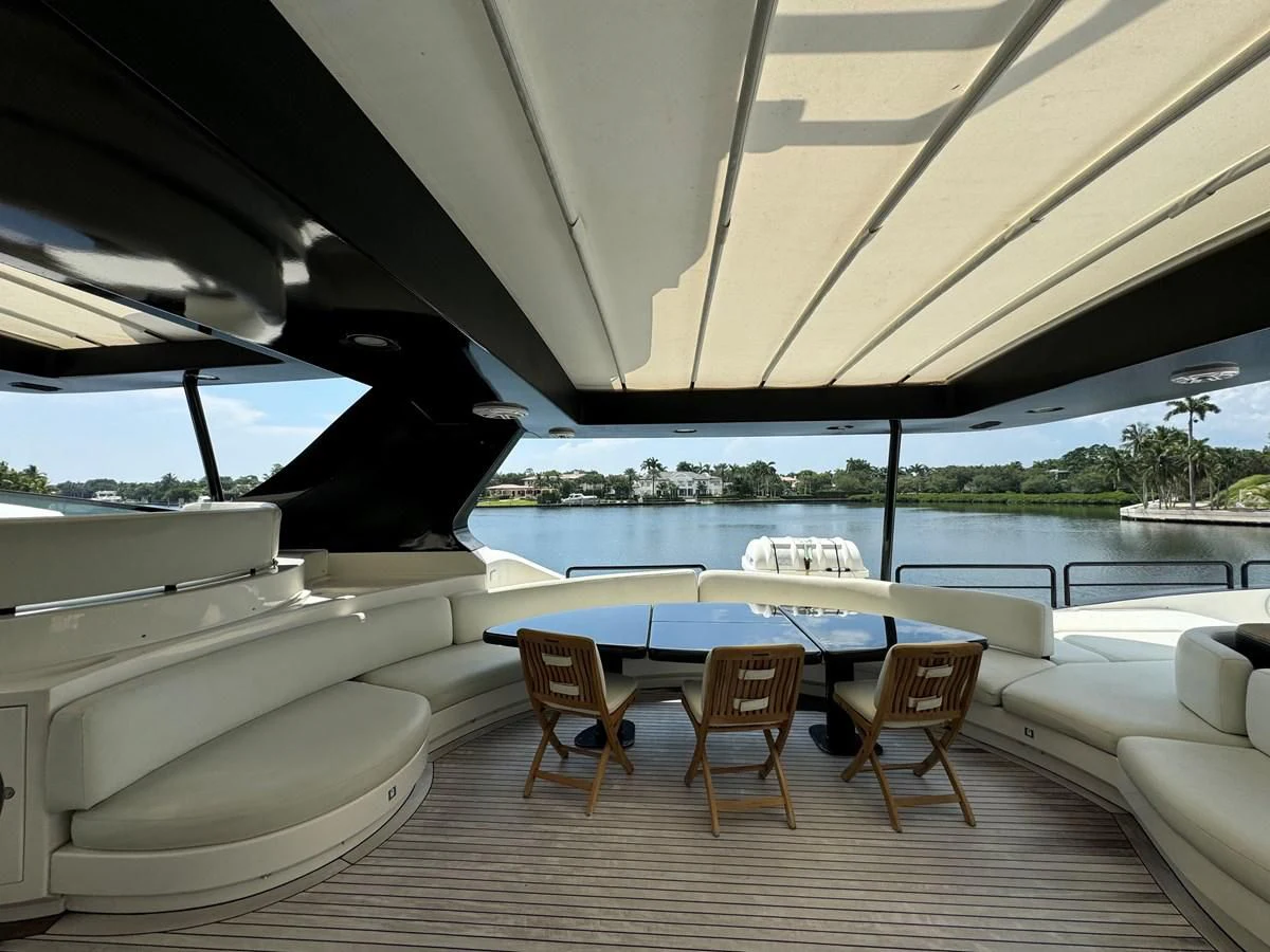 a patio with a table and chairs aboard AZIMUT 100/32 Yacht for Sale