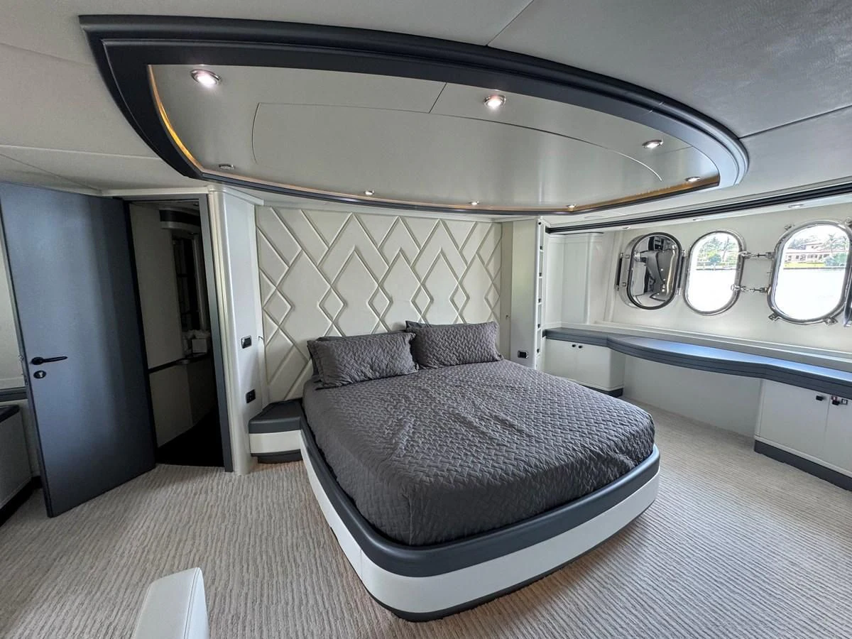 a room with a bed and a window aboard AZIMUT 100/32 Yacht for Sale