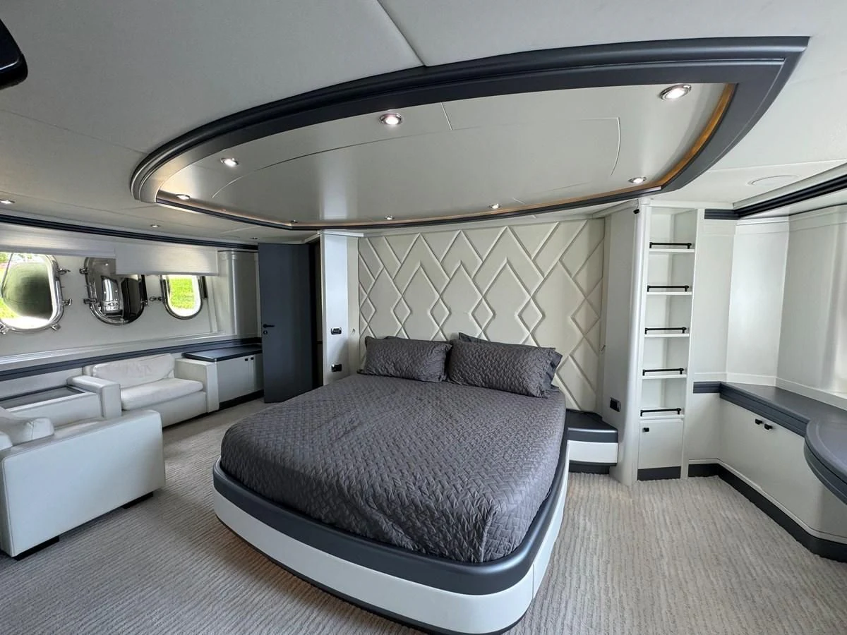 a room with a bed and a mirror aboard AZIMUT 100/32 Yacht for Sale