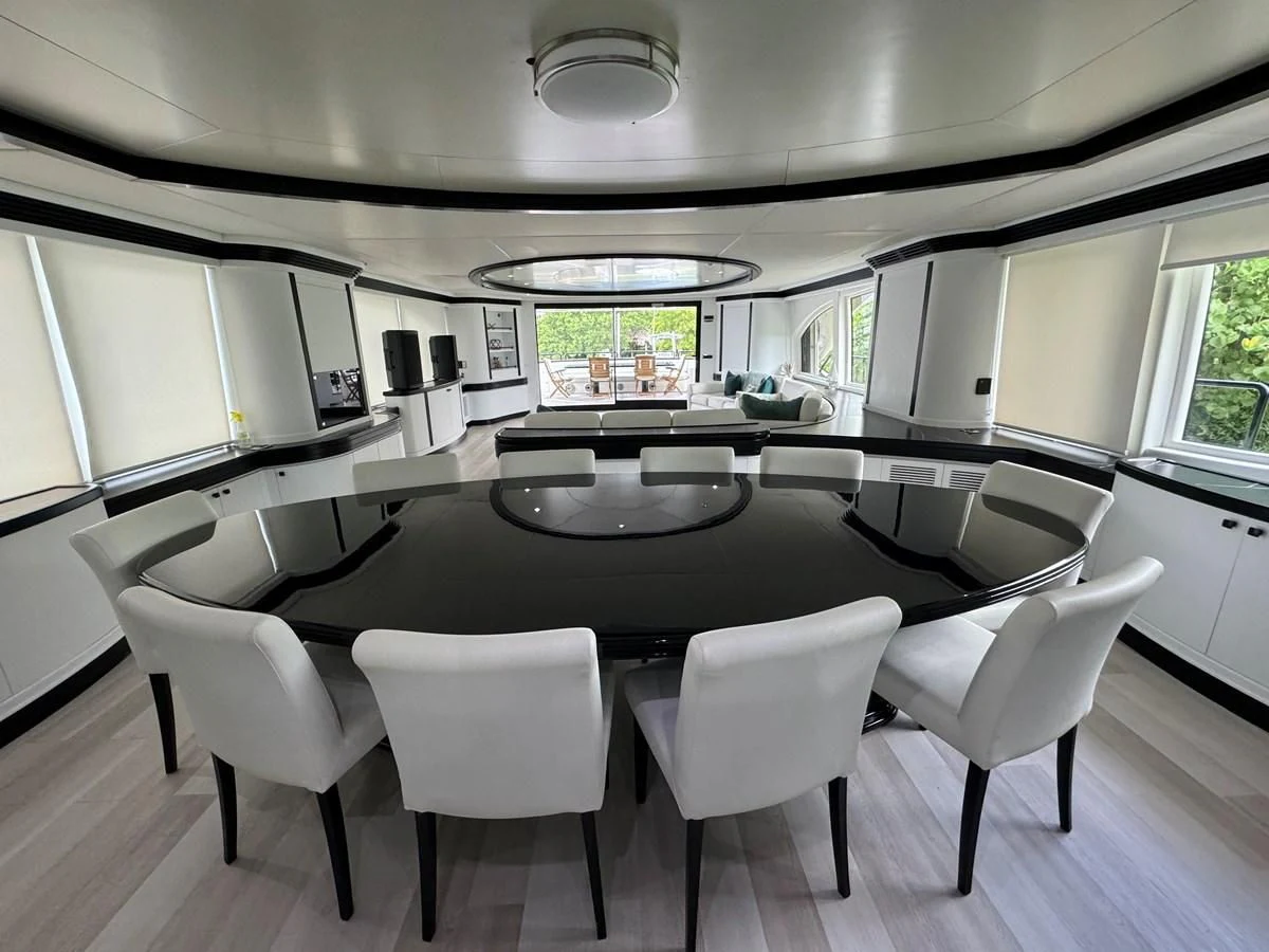 a table with chairs around it aboard AZIMUT 100/32 Yacht for Sale