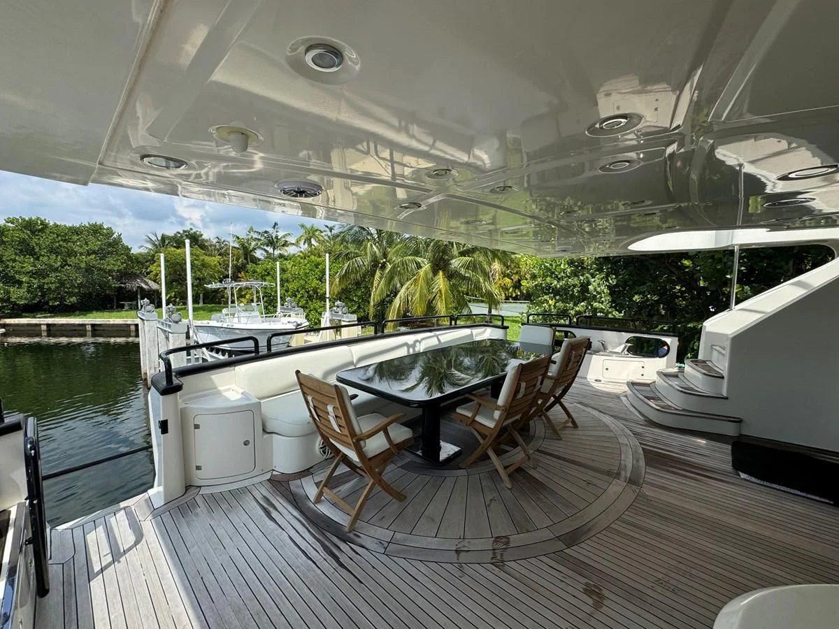 a deck with a table and chairs aboard AZIMUT 100/32 Yacht for Sale