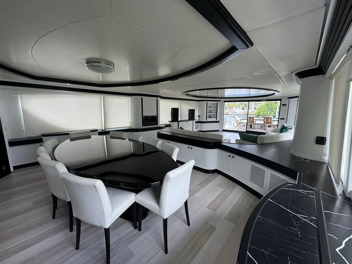 a room with a table and chairs aboard AZIMUT 100/32 Yacht for Sale
