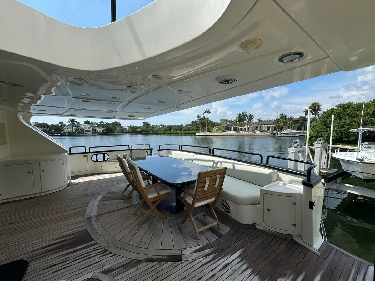 a large white and blue swimming pool with a deck and chairs and a large white building with trees aboard AZIMUT 100/32 Yacht for Sale