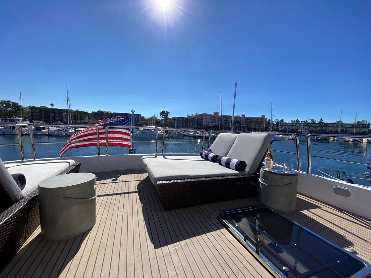 a deck with a chair and a table on it aboard AZIMUT 100/32 Yacht for Sale