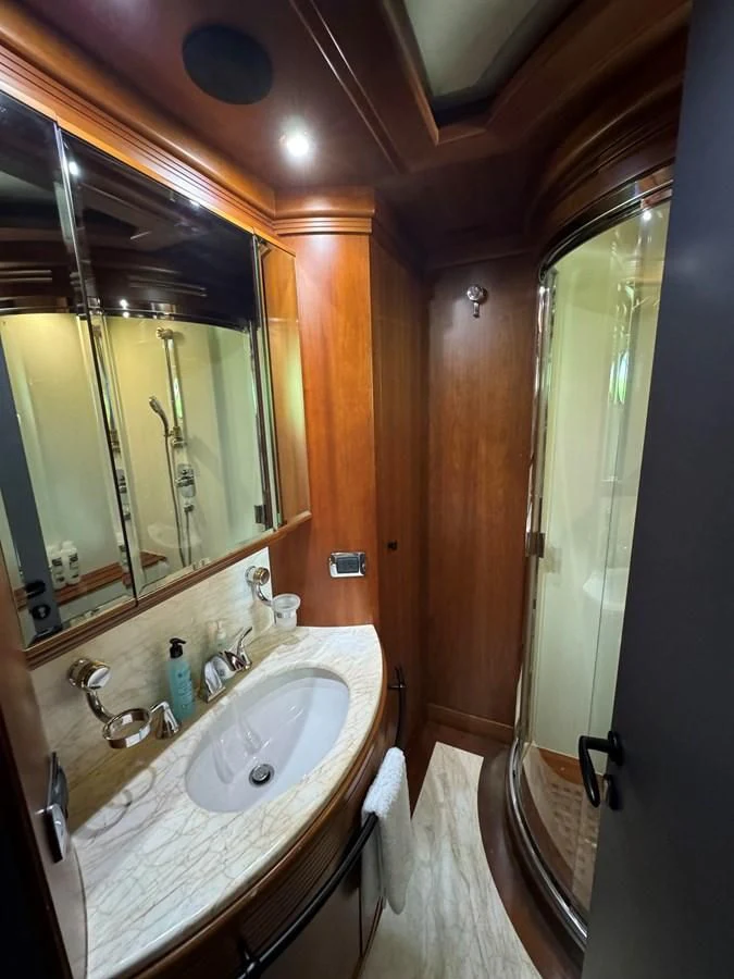 a bathroom with a sink and a mirror aboard AZIMUT 100/32 Yacht for Sale