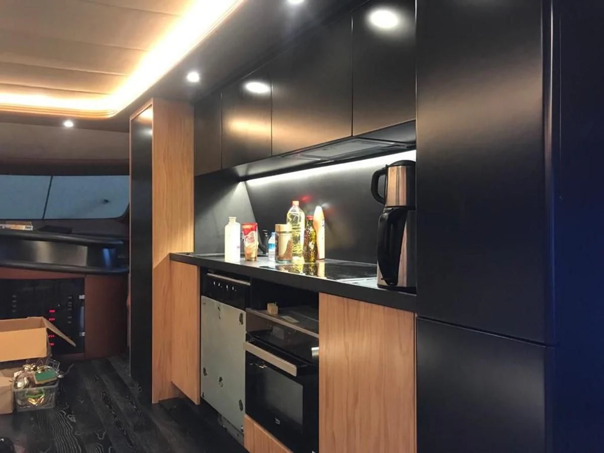 a kitchen with a fridge and a lot of food on the counter aboard AZIMUT 100/32 Yacht for Sale