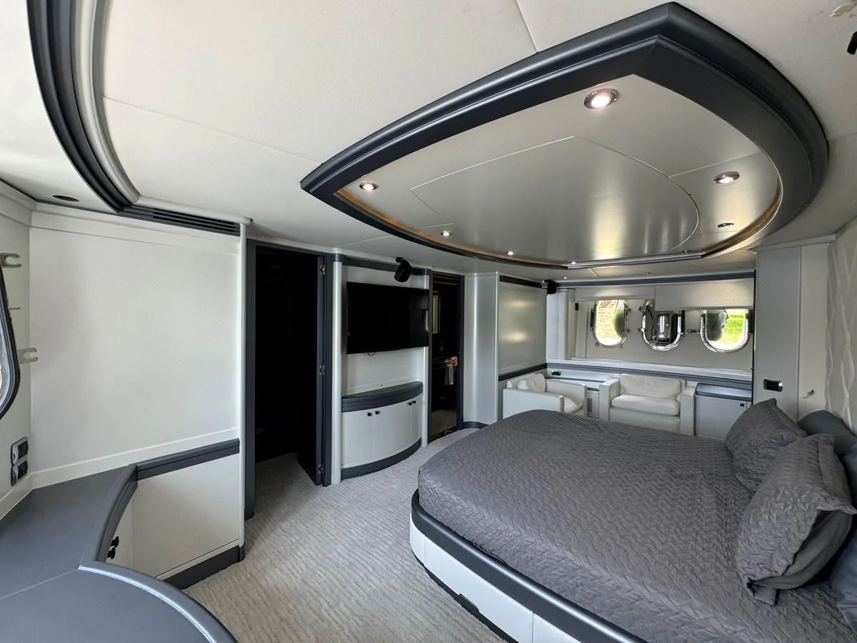 a room with a bed and a large mirror aboard AZIMUT 100/32 Yacht for Sale