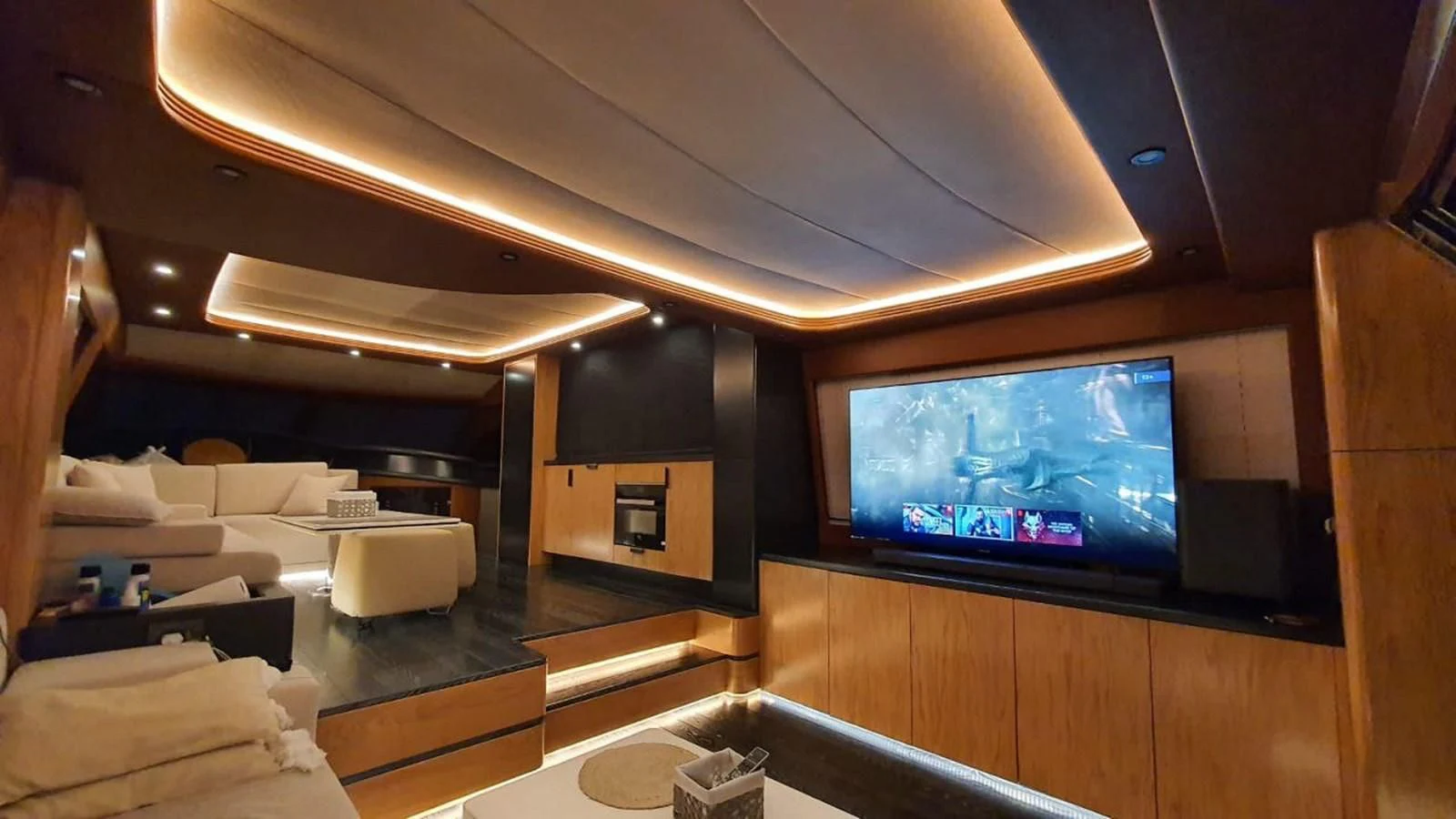 a room with a tv and furniture aboard AZIMUT 100/32 Yacht for Sale
