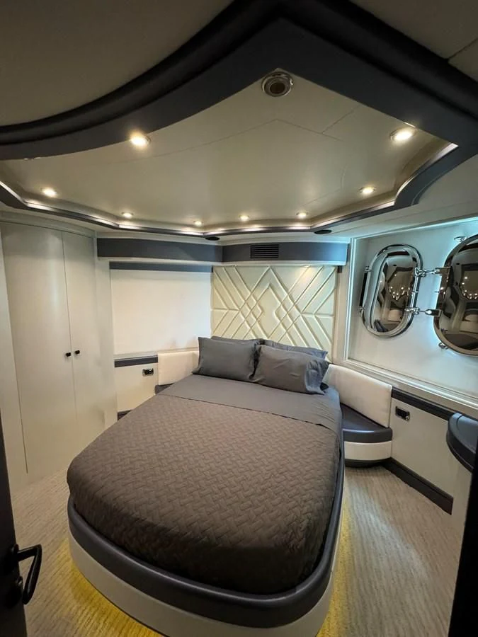 a room with a bed and a mirror aboard AZIMUT 100/32 Yacht for Sale