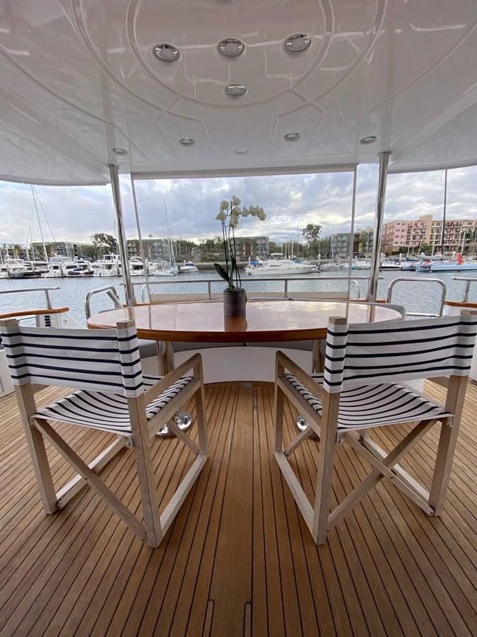 a table and chairs on a deck aboard AZIMUT 100/32 Yacht for Sale