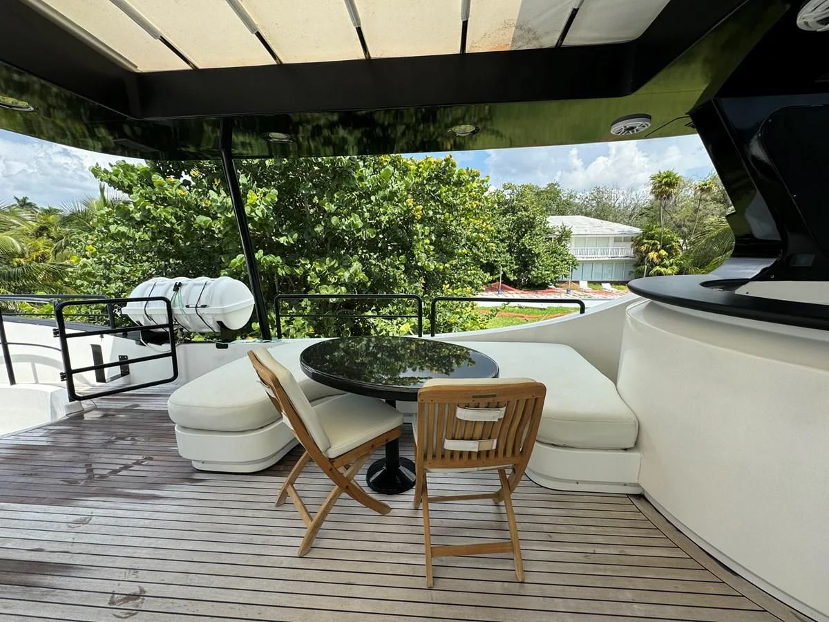a table and chairs on a deck aboard AZIMUT 100/32 Yacht for Sale
