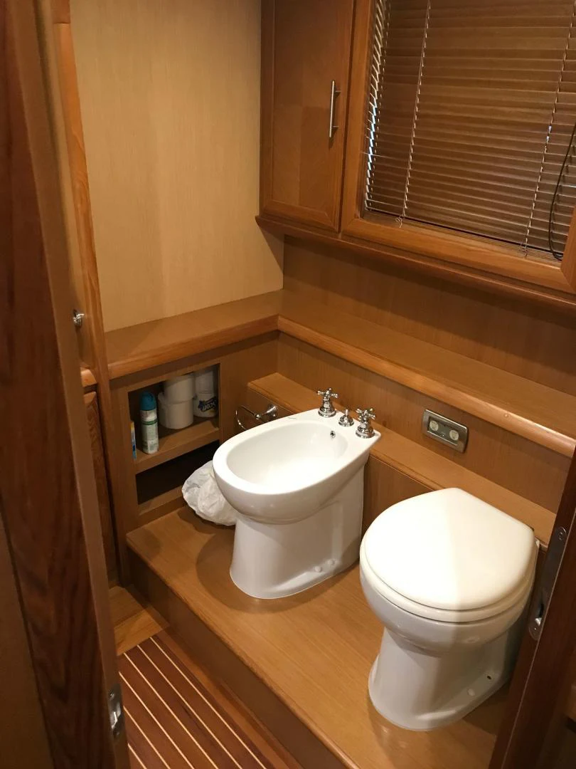 a toilet and sink in a bathroom aboard KNOT NANNY'S Yacht for Sale