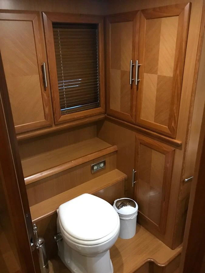a toilet in a wooden bathroom aboard KNOT NANNY'S Yacht for Sale