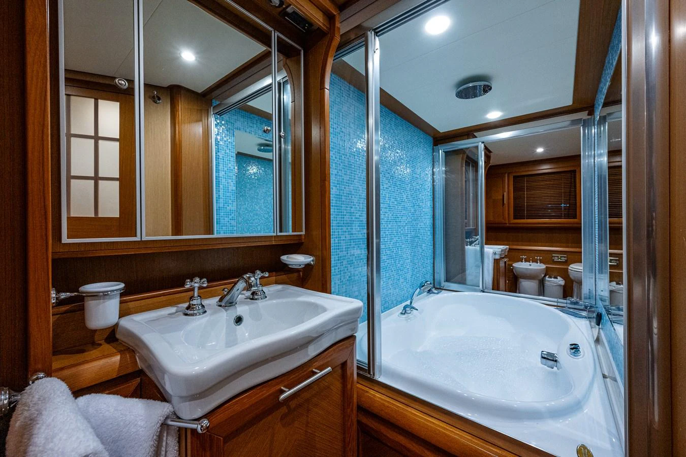 a bathroom with a tub sink and a mirror aboard KNOT NANNY'S Yacht for Sale