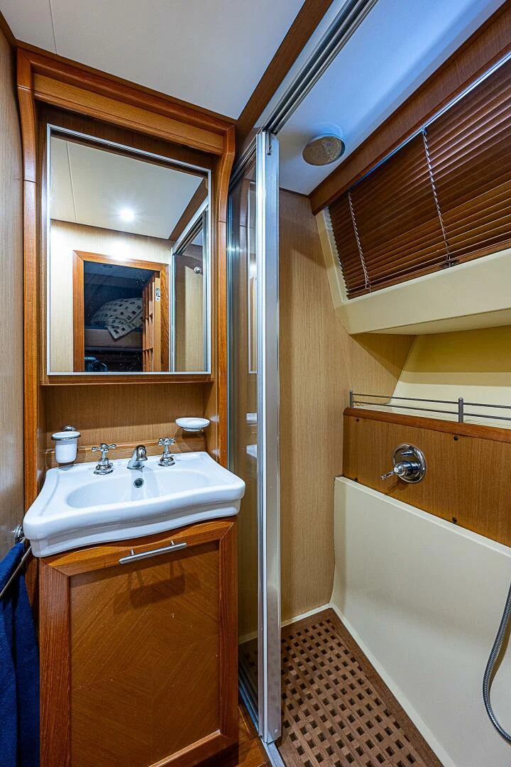 a bathroom with a sink and mirror aboard KNOT NANNY'S Yacht for Sale