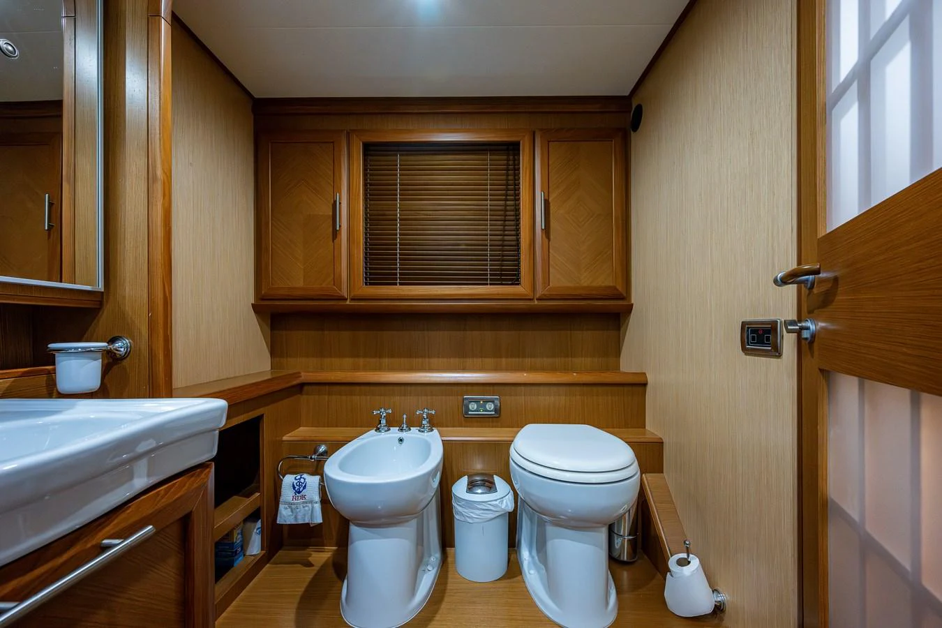 a bathroom with wooden cabinets aboard KNOT NANNY'S Yacht for Sale
