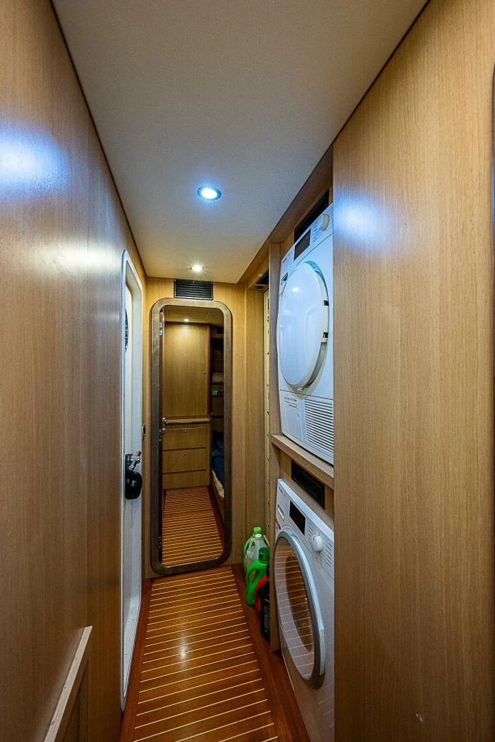 a hallway with a door and a clock on the wall aboard KNOT NANNY'S Yacht for Sale