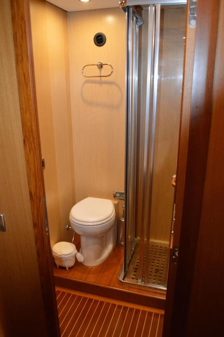 a bathroom with a glass shower door aboard KNOT NANNY'S Yacht for Sale