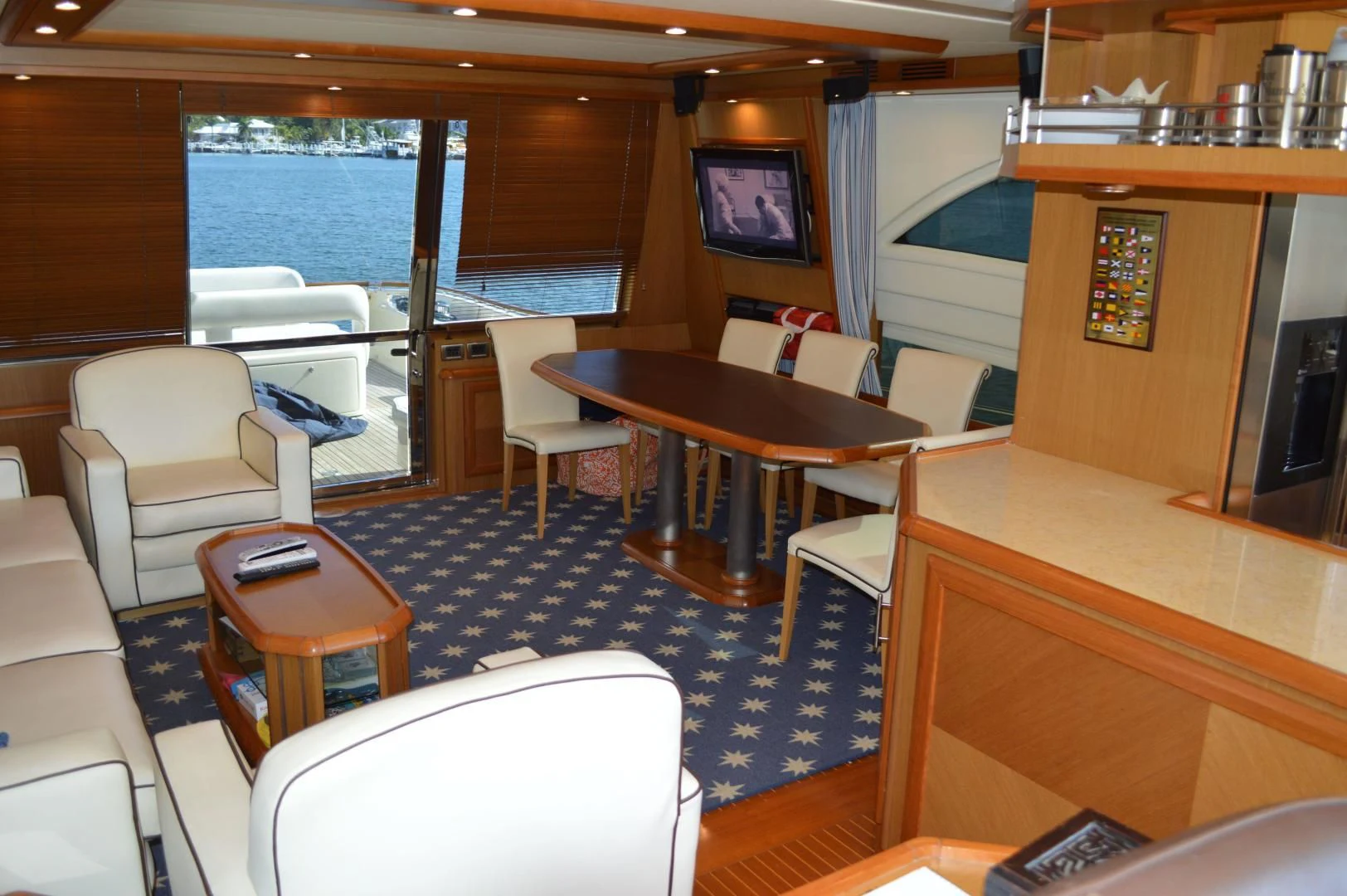 a room with a table chairs and a tv aboard KNOT NANNY'S Yacht for Sale