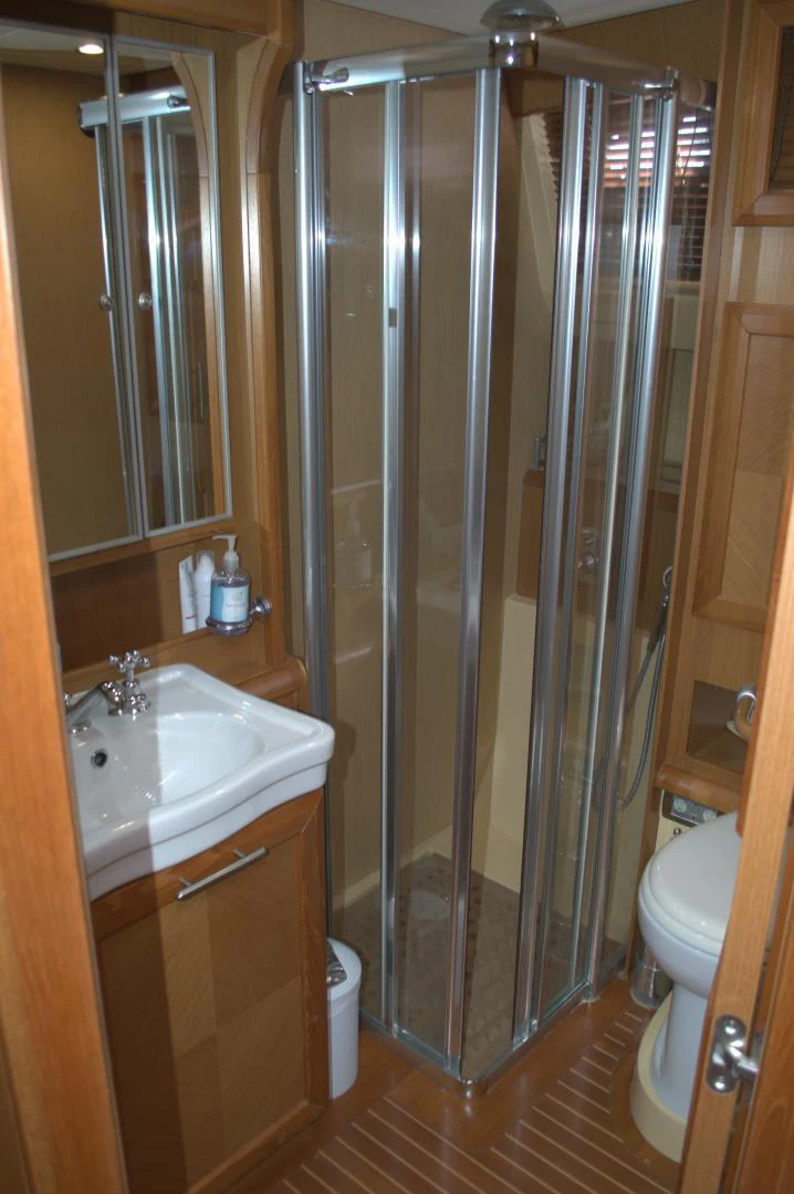 a bathroom with a shower unit and sink aboard KNOT NANNY'S Yacht for Sale