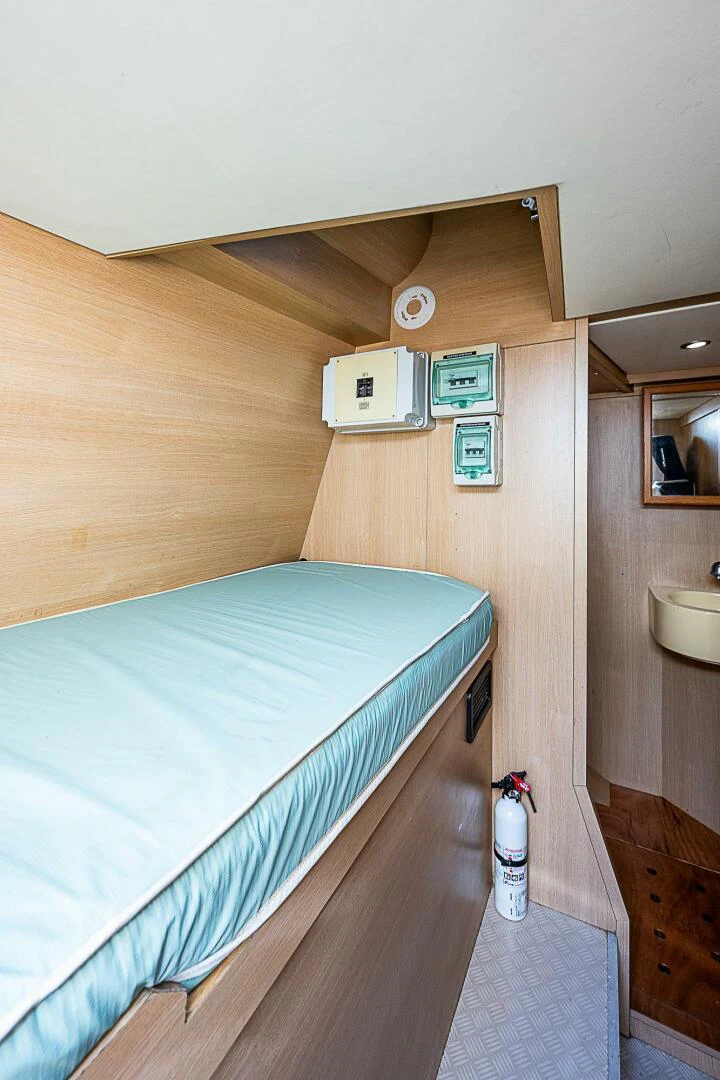 a bed with a blue sheet aboard KNOT NANNY'S Yacht for Sale