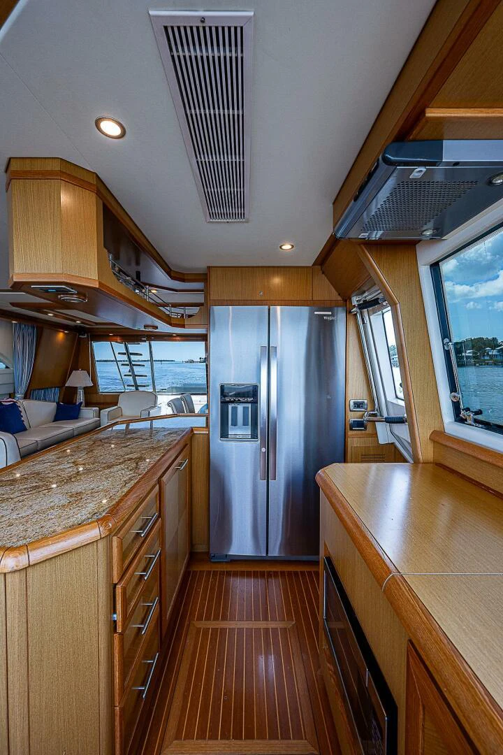 a kitchen with a stainless steel refrigerator aboard KNOT NANNY'S Yacht for Sale