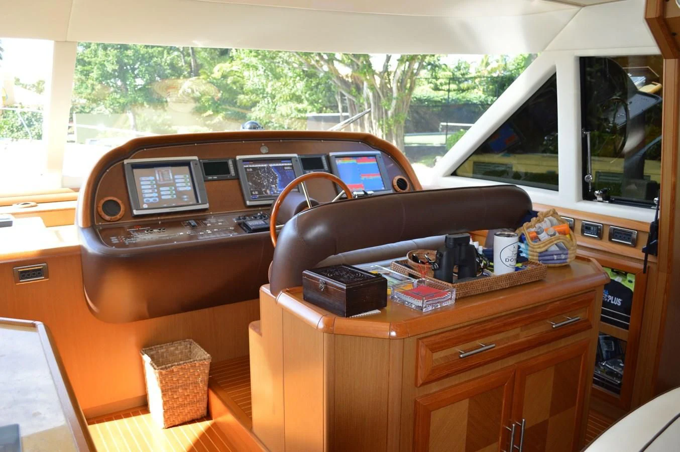 a wooden desk with a computer and other objects on it aboard KNOT NANNY'S Yacht for Sale