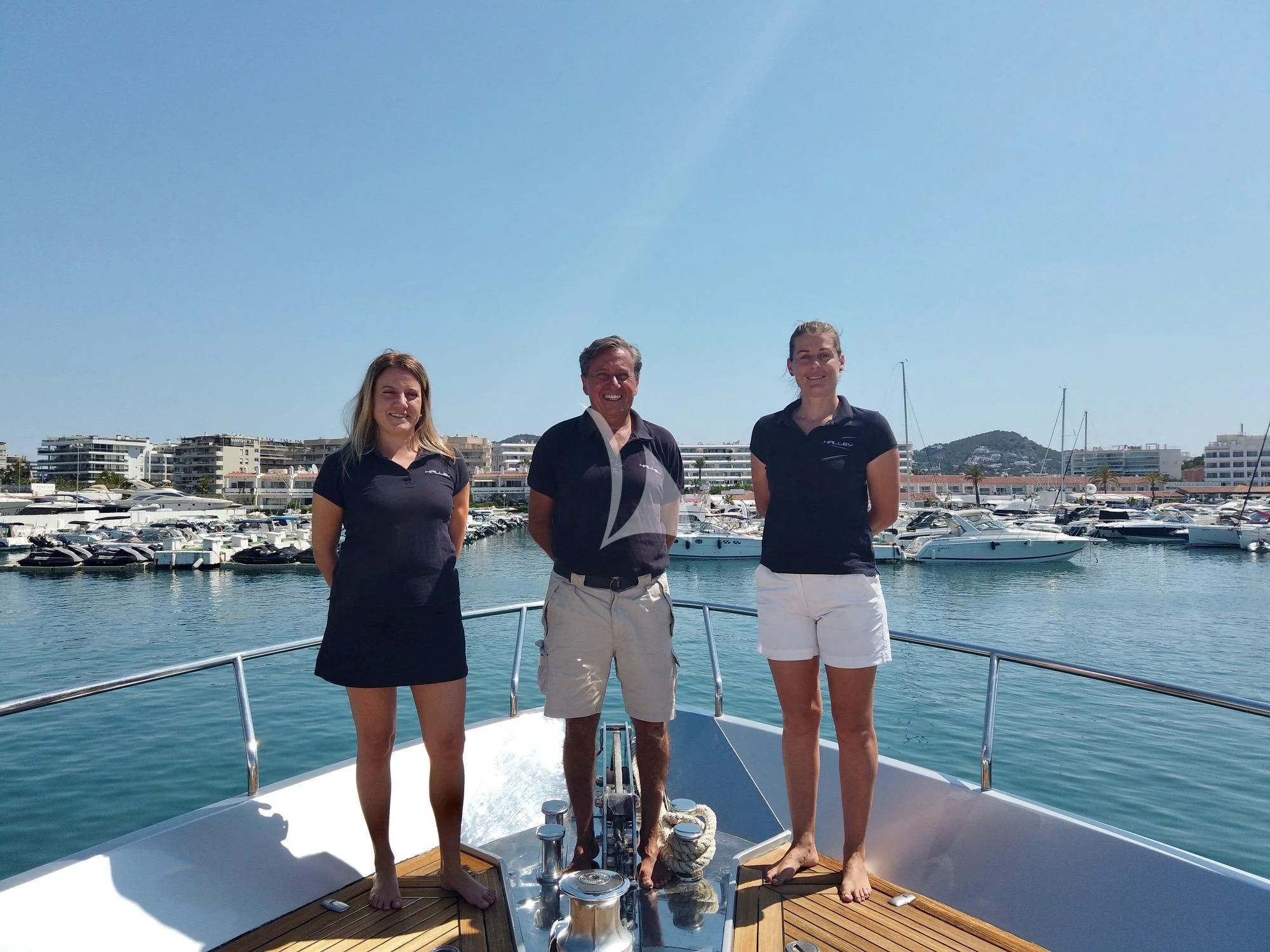 a group of people standing on a dock by a body of water aboard WAHOO Yacht for Sale