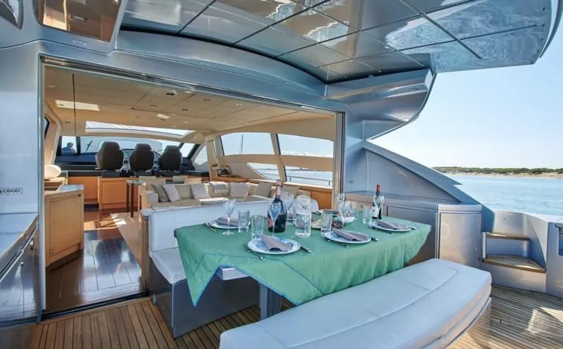 a table with a glass and a bottle on it aboard WAHOO Yacht for Sale
