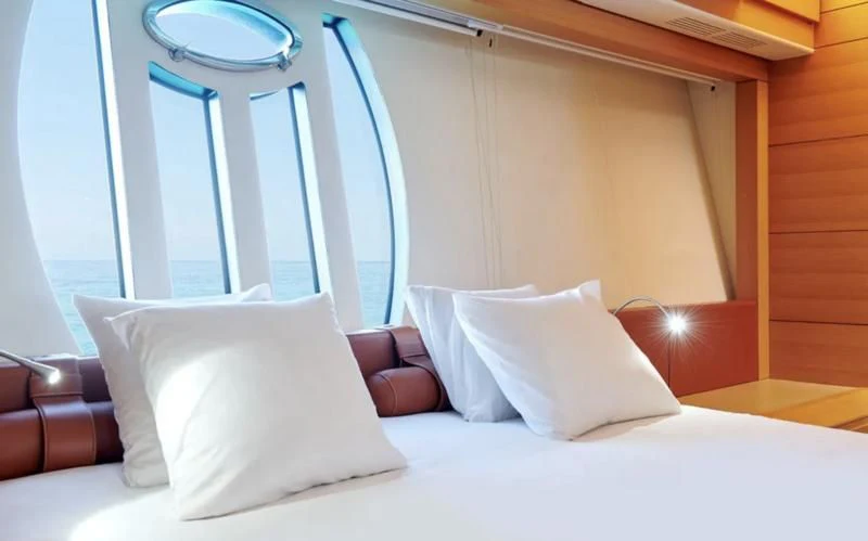 a bed with pillows aboard WAHOO Yacht for Sale