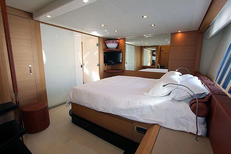a room with a bed and a television aboard WAHOO Yacht for Sale