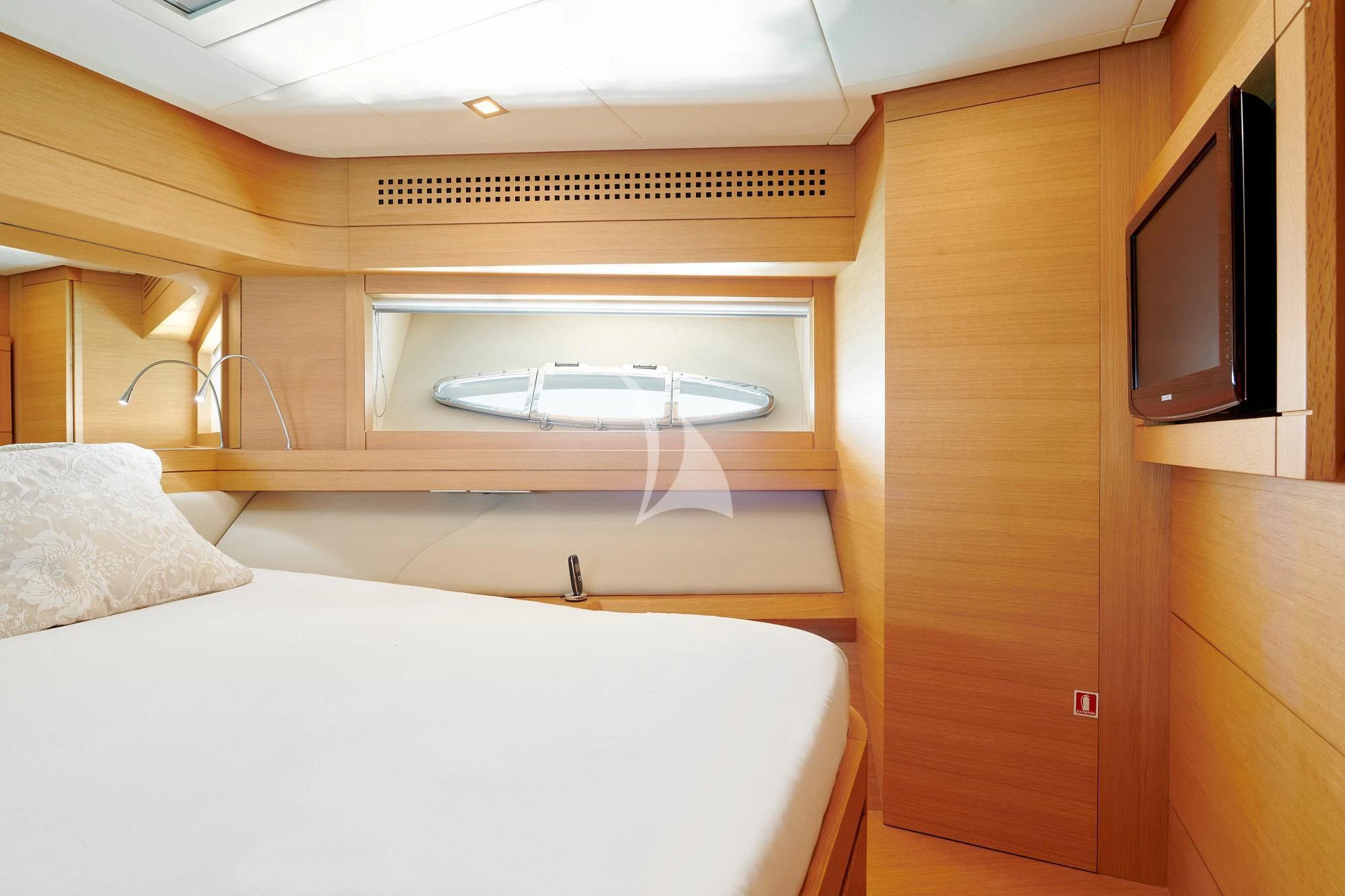 a bedroom with a bed and a television aboard WAHOO Yacht for Sale
