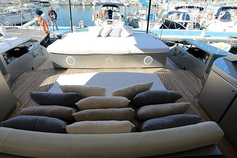 a large white boat with black cushions aboard WAHOO Yacht for Sale